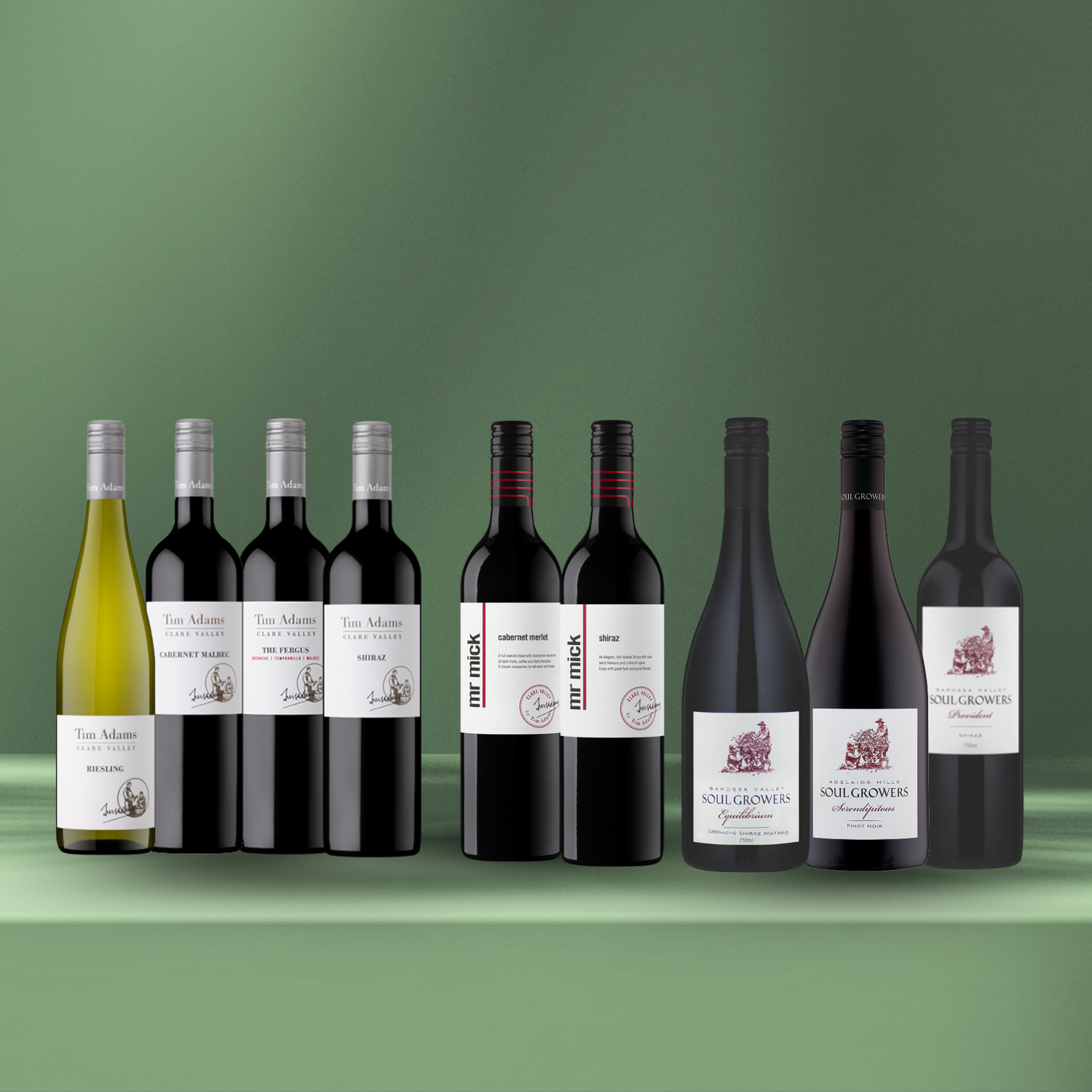 Collection of wine bottles with labels on a green background